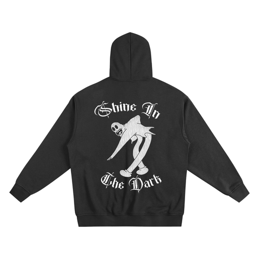 Black hoodie with chicano art graphics and Shine in the dark on back in old english letter fonts- premium chicano fashion & lowrider style streetwear
