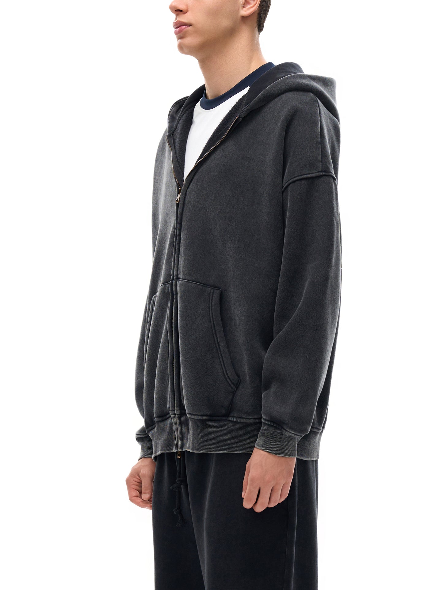 Person wearing a dark gray hoodie on a white background-premium chicano clothing & Lowrider style streetwear